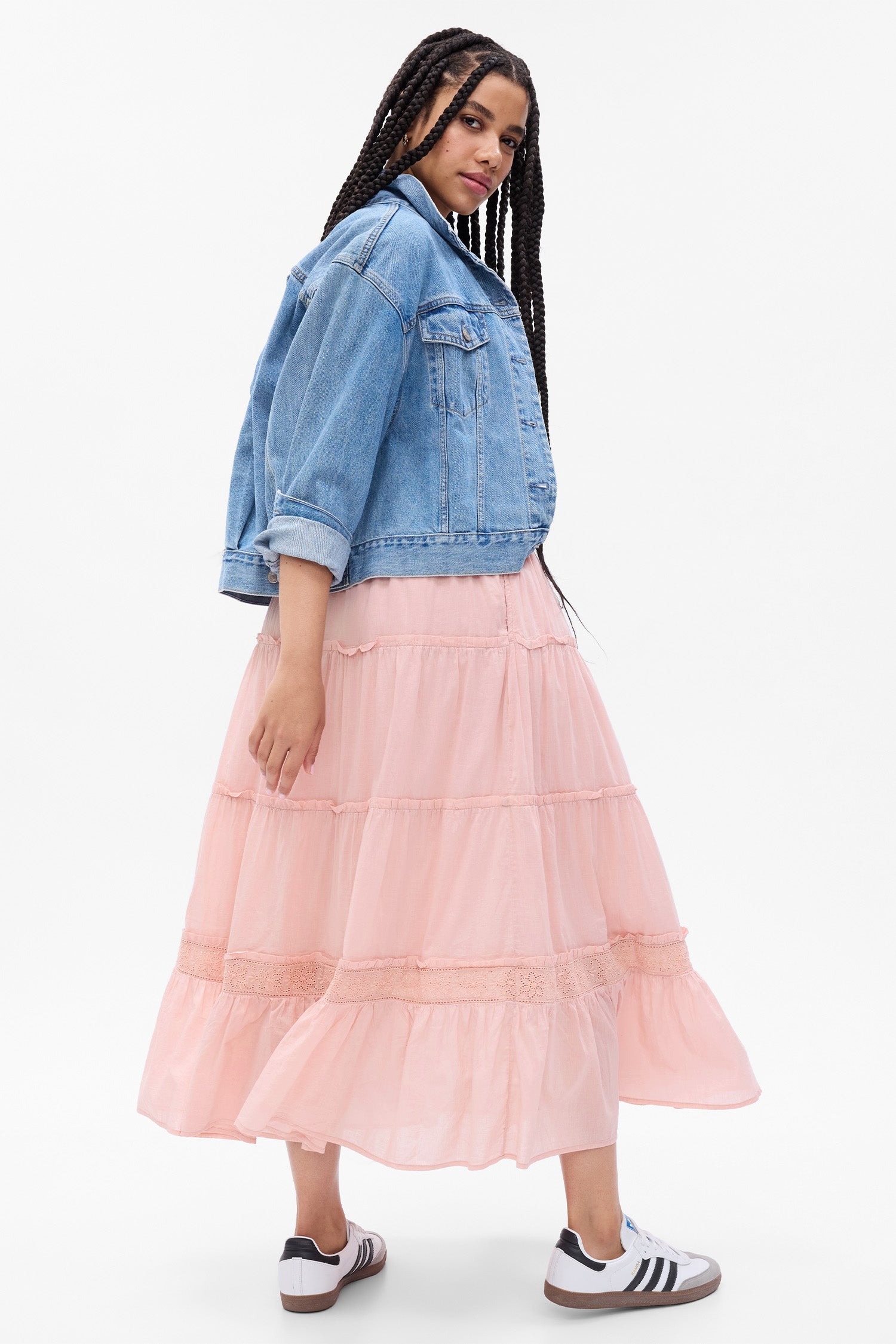 Back image of model wearing pink tiered maxi skirt with eyelet detail