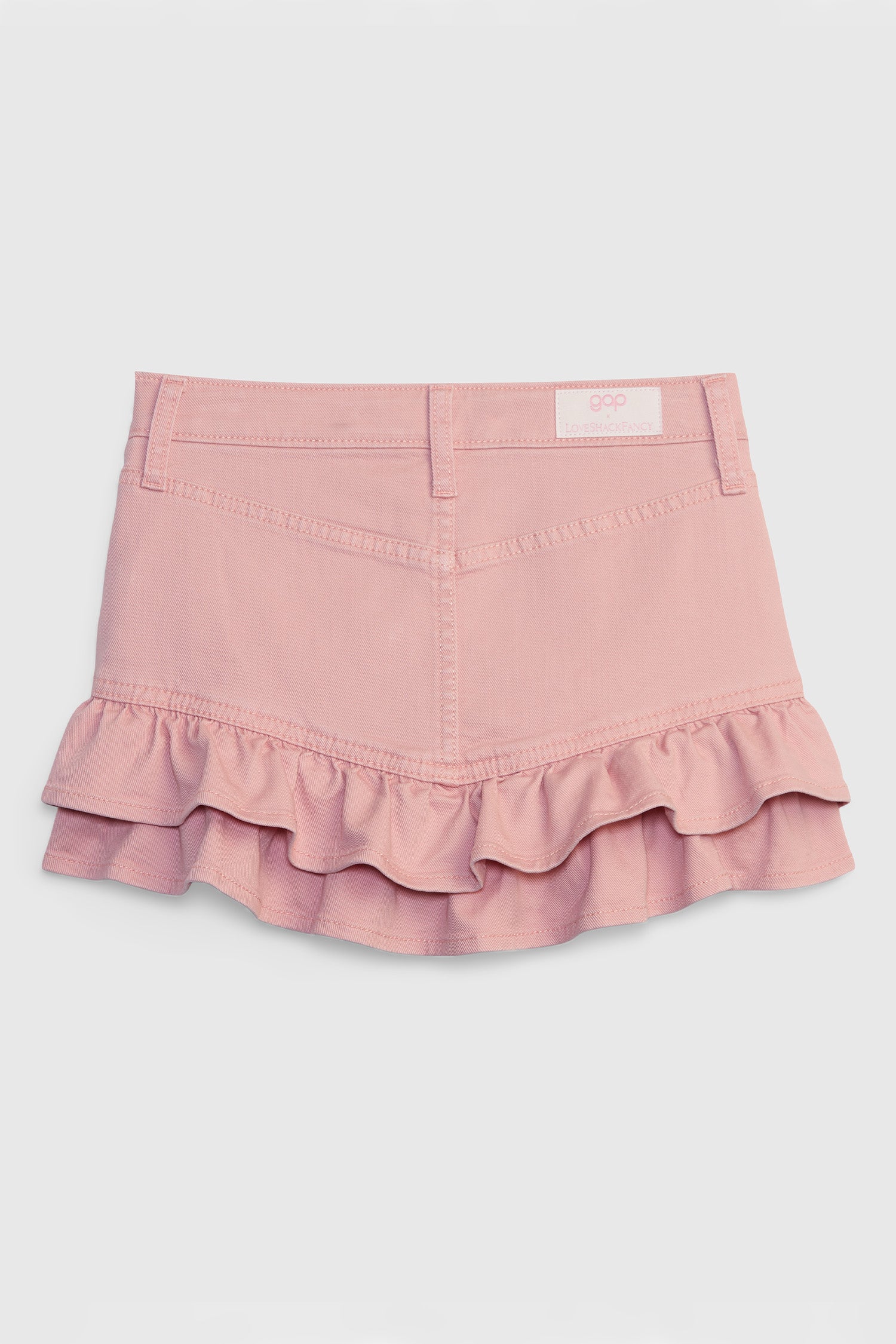 Back image of pink denim mini skirt with ruffle hem