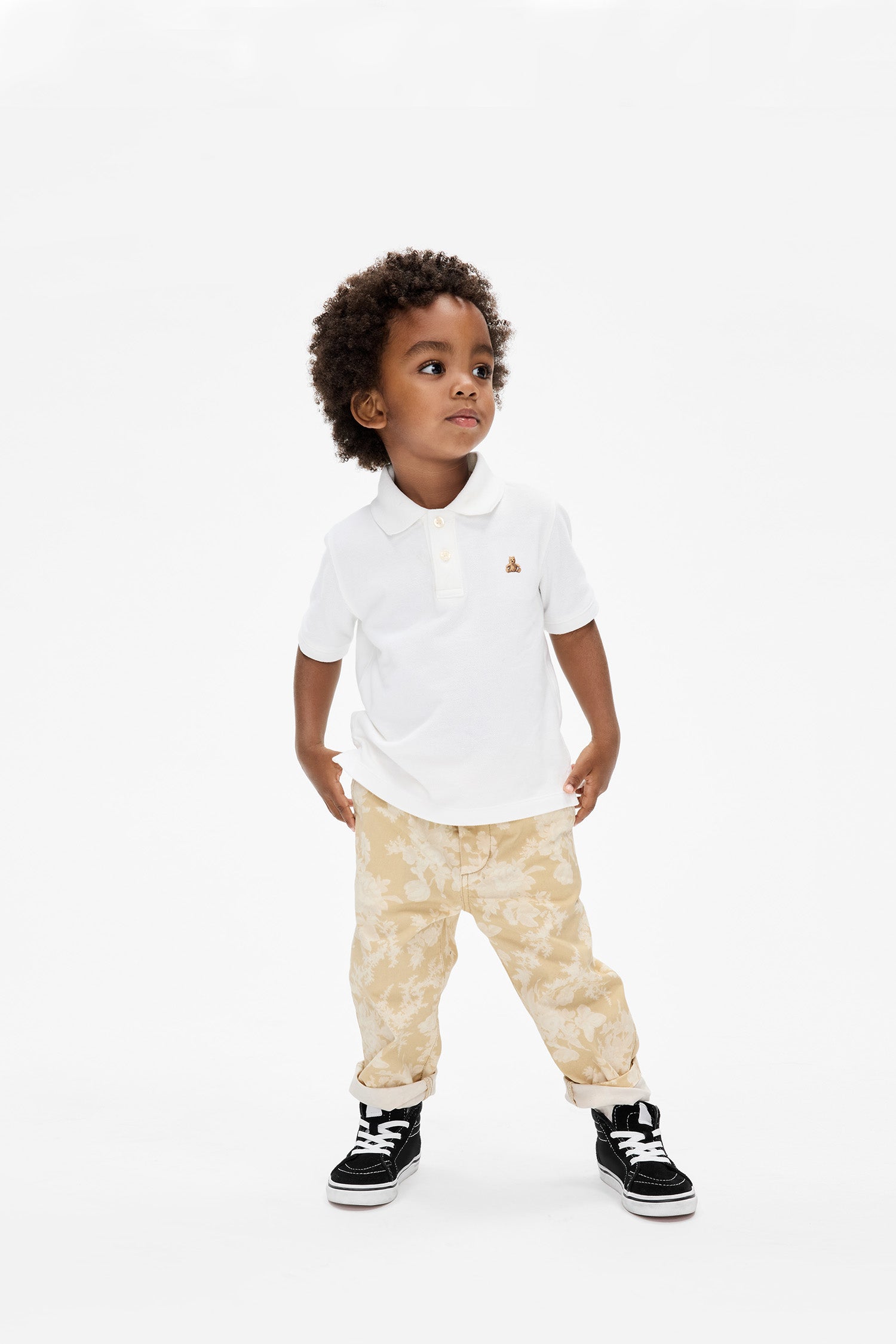 Model wearing boy's toddler cream floral khakis. 