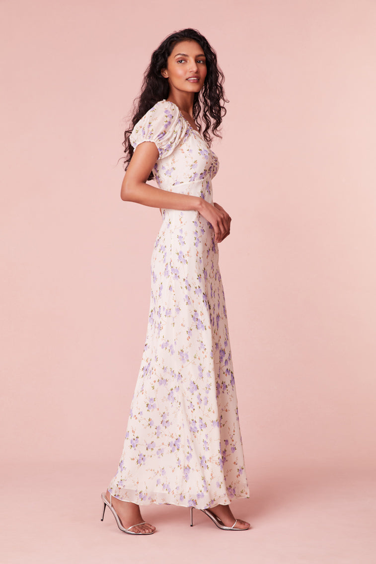 Floral printed maxi dress with short puff sleeves, a slightly square neckline with ruching at center front, and a breezy maxi skirt.
