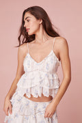 Victorian-inspired tank features embroidered mesh with scalloped edges and ruffle detailing in blue floral print.