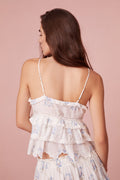 Victorian-inspired tank features embroidered mesh with scalloped edges and ruffle detailing in blue floral print.