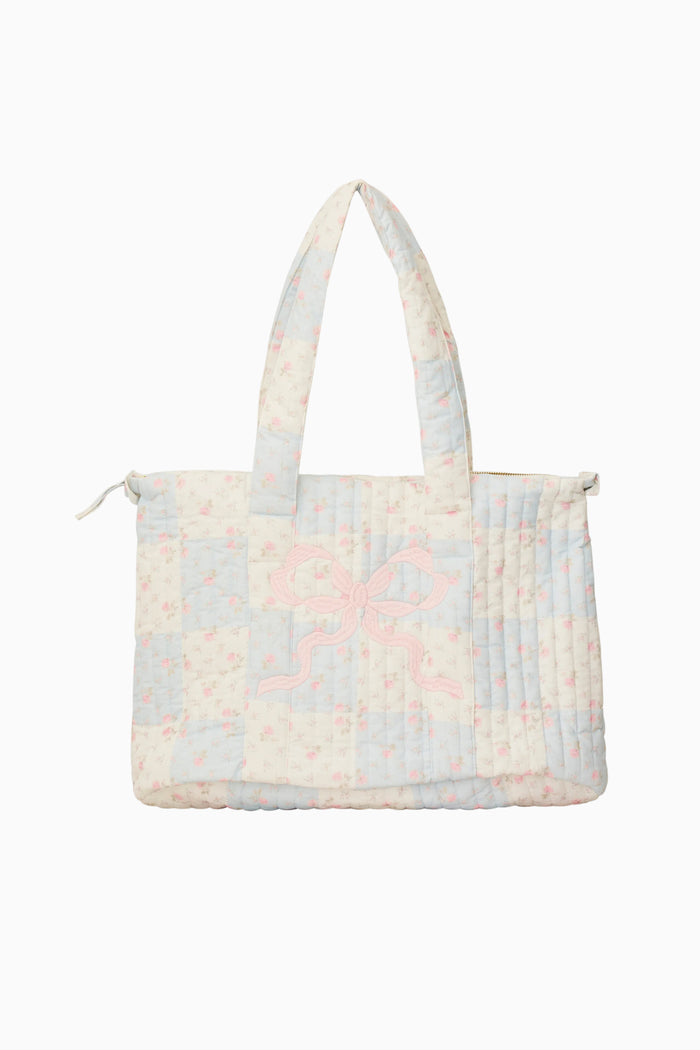 Floral patterned quilted tote bag on a white background