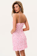Woman wearing a pink floral dress on a white background