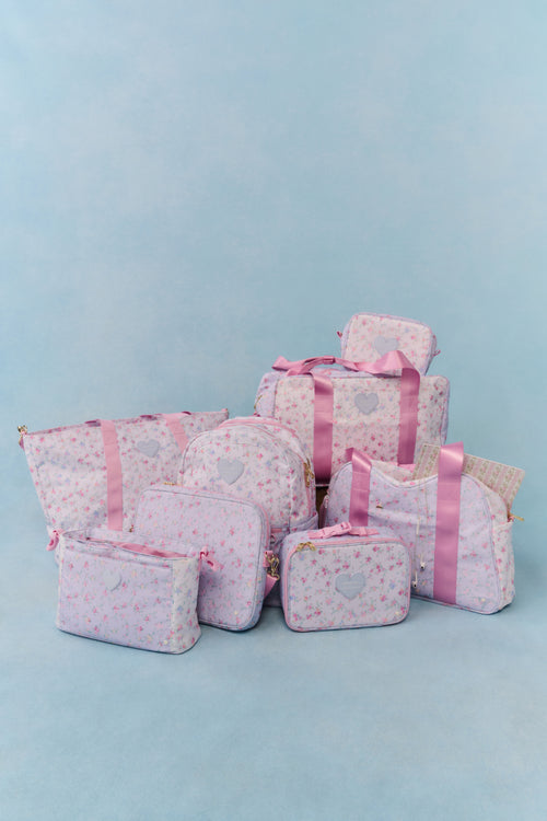 Set of pink bags with heart patterns on a light blue background