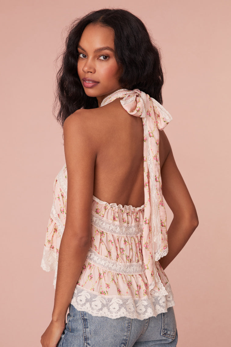 Floral print  halter top ties with a knot at the back, bodice has elastic and then falls into a playful trapeze shape with laces woven throughout.