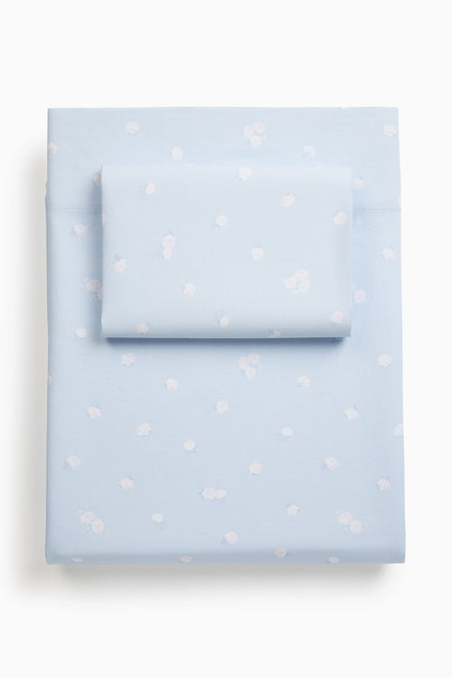 Light blue sheet set stacked with a subtle pattern on a white background