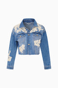 Blue denim jacket with floral lace embroidery on a white background