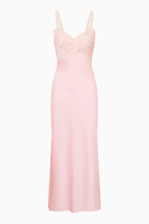 Pink silk gown with lace detailing on a white background