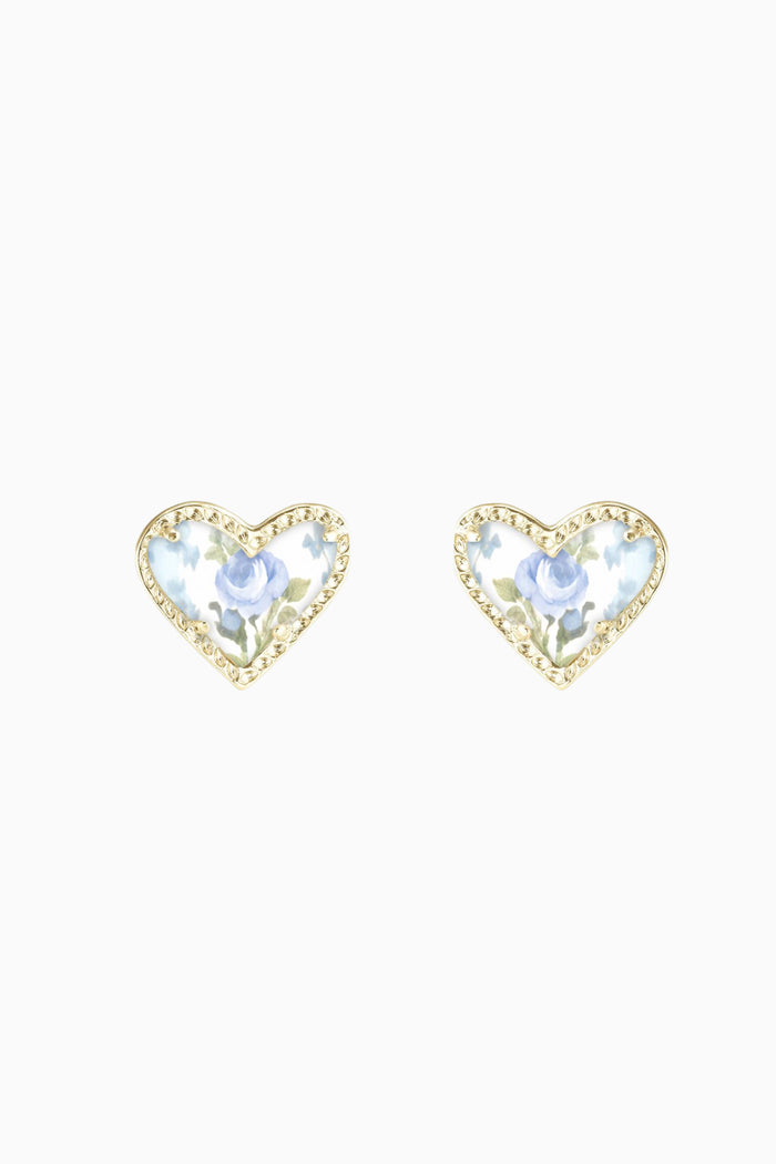 Heart-shaped earrings with clear gemstones and floral heart print center on a white background