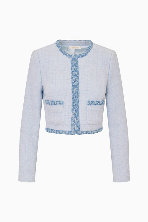 Light blue tweed jacket with decorative trim on a white background