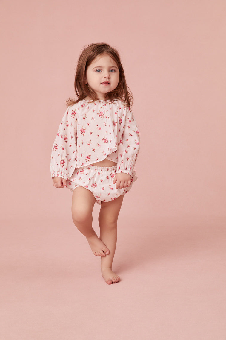 Baby top with ditsy floral print and long sleeves.