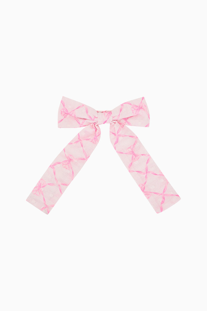 Pink and white patterned bow on a white background