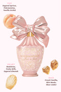Pink perfume travel spray with oversized bow and gold cap on a vanity tray.