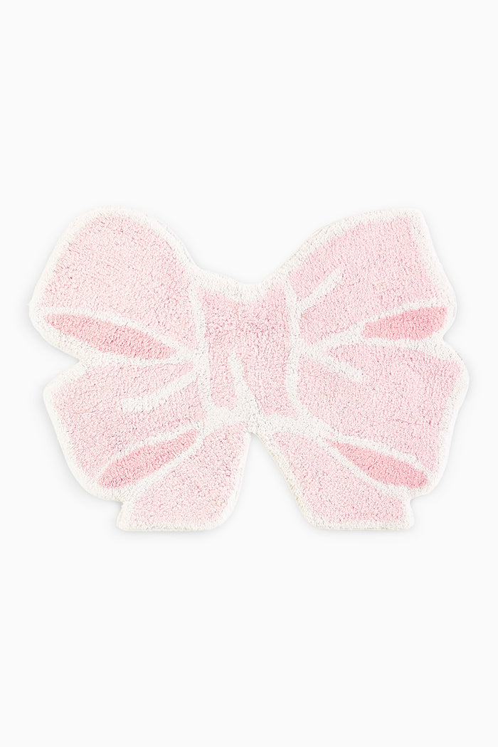 Pink fluffy bow rug on a white background