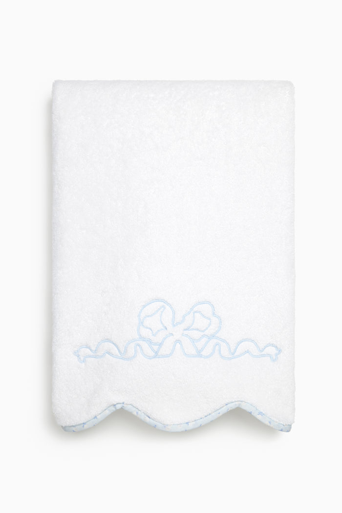 White towel with blue embroidery on a white background