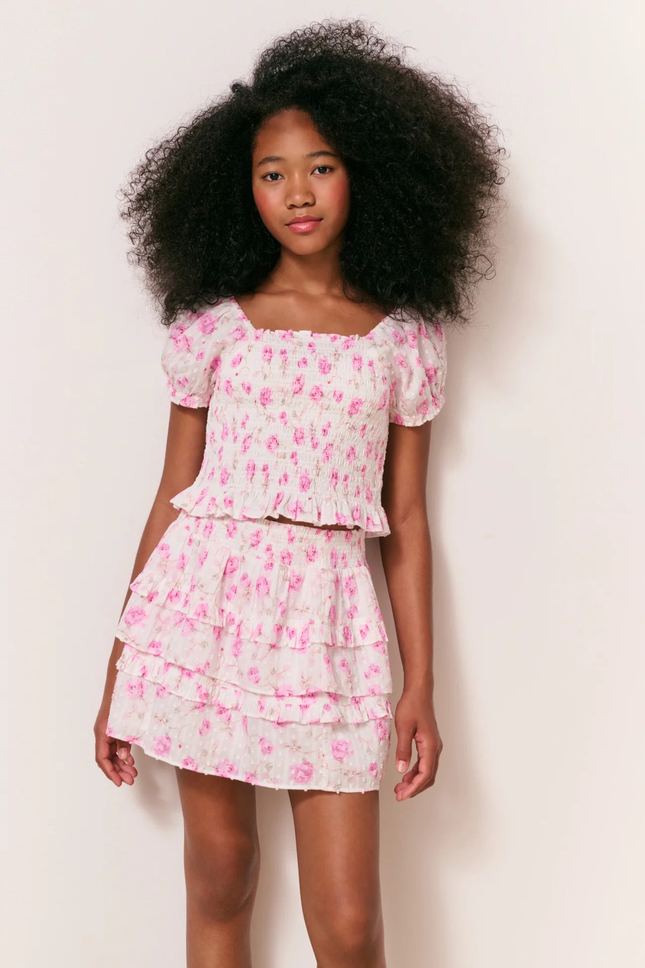 Women sitting in grass field wearing LoveShackFancy Slip Dresses