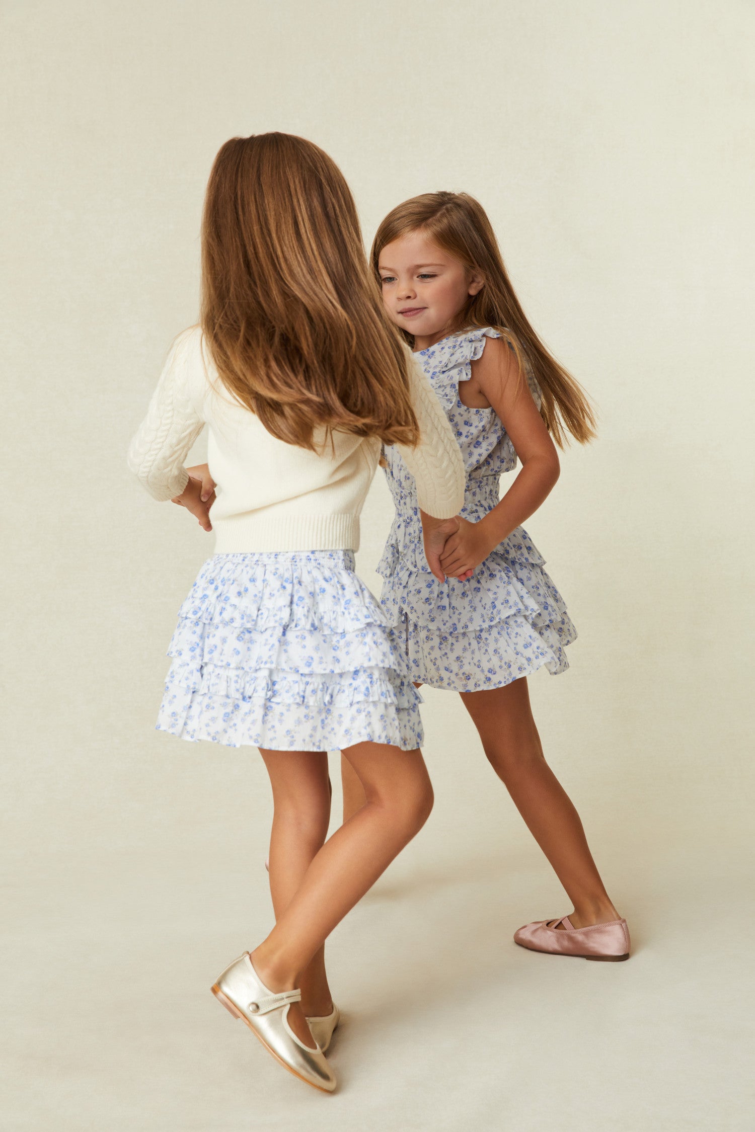 Girls white skirt with tiny blue flowers - wide smocked waistband, the skirt falls to two shirred tiers with ruffle details.