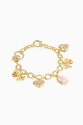 Gold charm bracelet with various charms on a white background