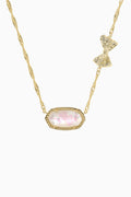 Gold necklace with a pink gemstone pendant on a white background