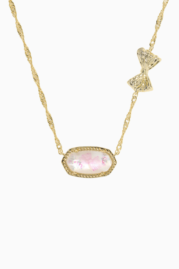 Gold necklace with a pink gemstone pendant on a white background