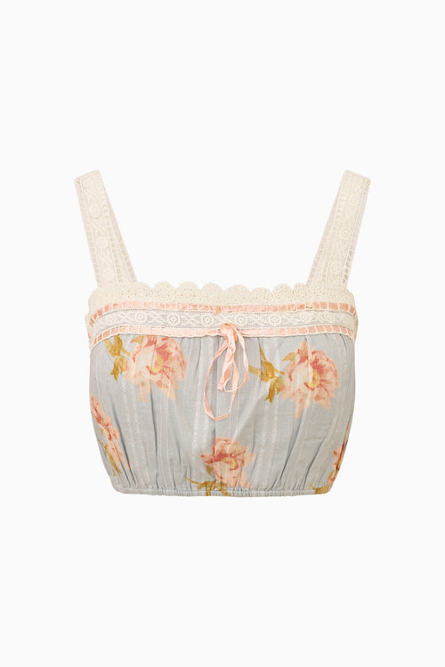 Floral-patterned cropped top with lace trim on a white background