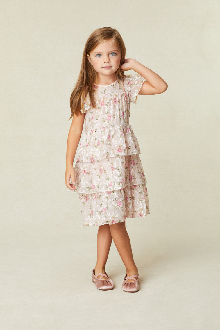 Beautiful Floral Print Dress with Flutter sleeves frame the roomy bodice. An encased elastic waist lets out into a three-tiered ruffle skirt. 