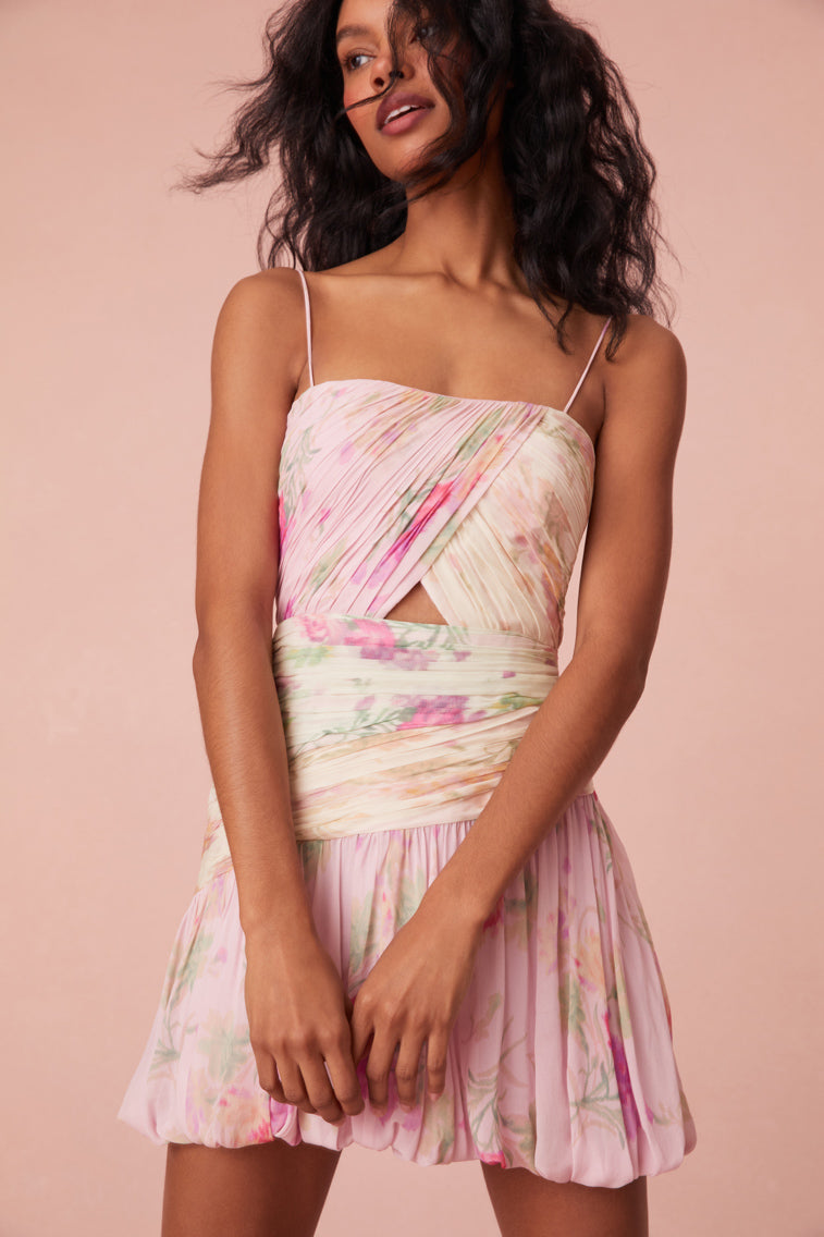Mini ruched dress with tiny spaghetti straps, a structured bodice with keyhole detail at center front that descends to a bubble skirt with a playful asymmetrical hem.