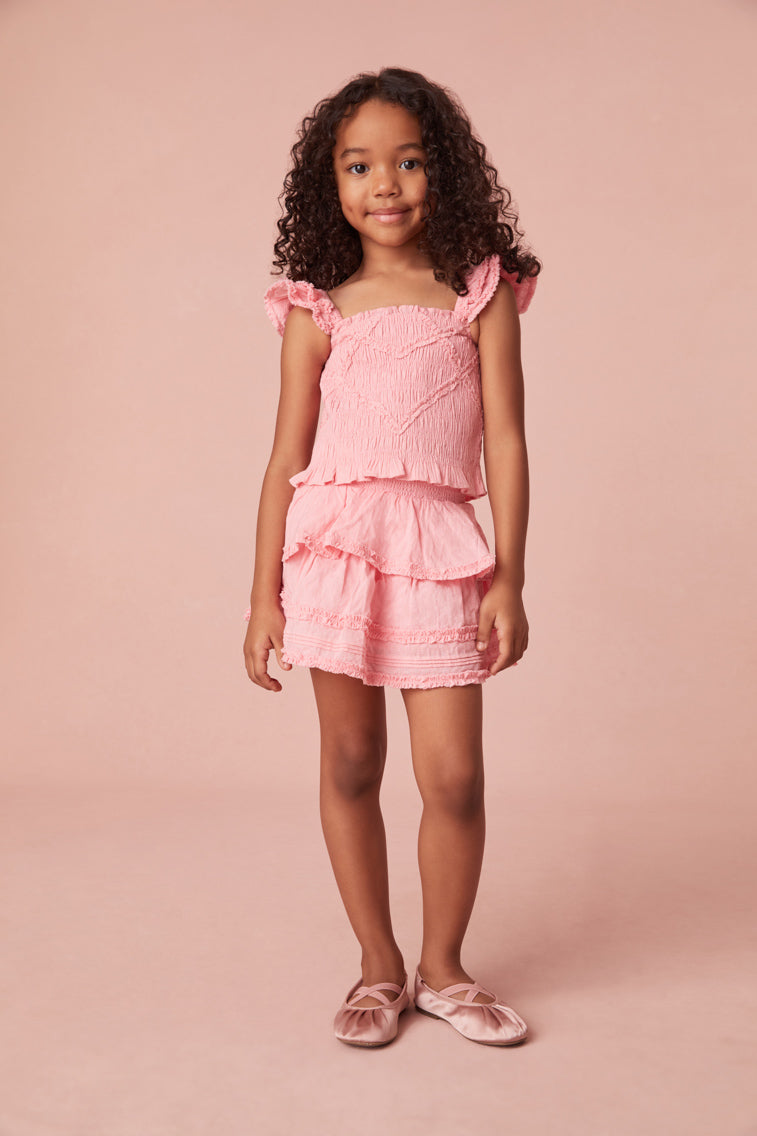 Girls top with tiny flutter sleeves, ruffle smocking all over, and a dainty ruffle peplum hem. 