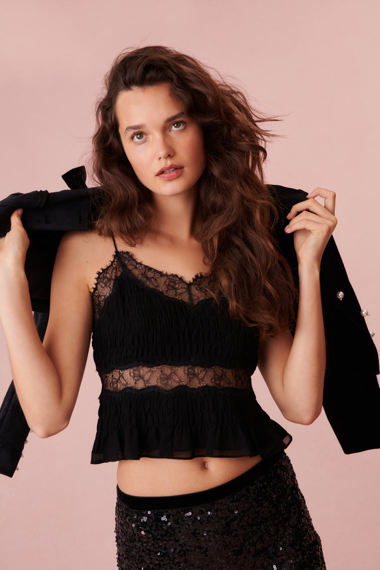 Tiny spaghetti strap black top with sheer scalloped lace details.