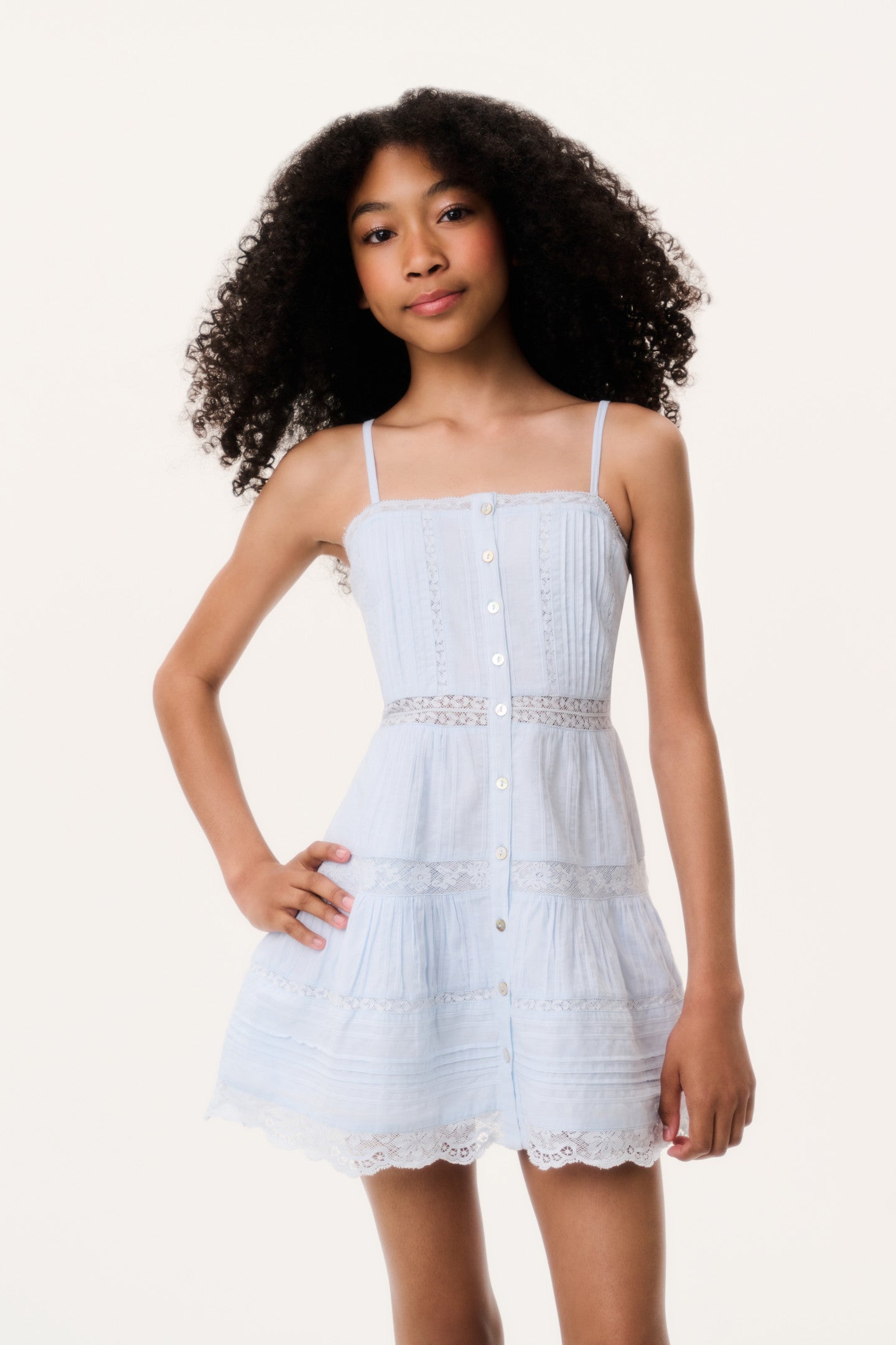 Women sitting in grass field wearing LoveShackFancy Slip Dresses