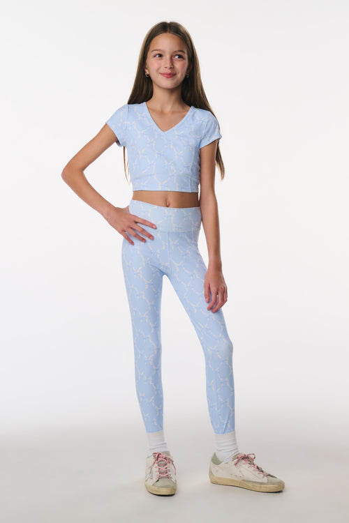 Girl wearing a light blue outfit on a white background