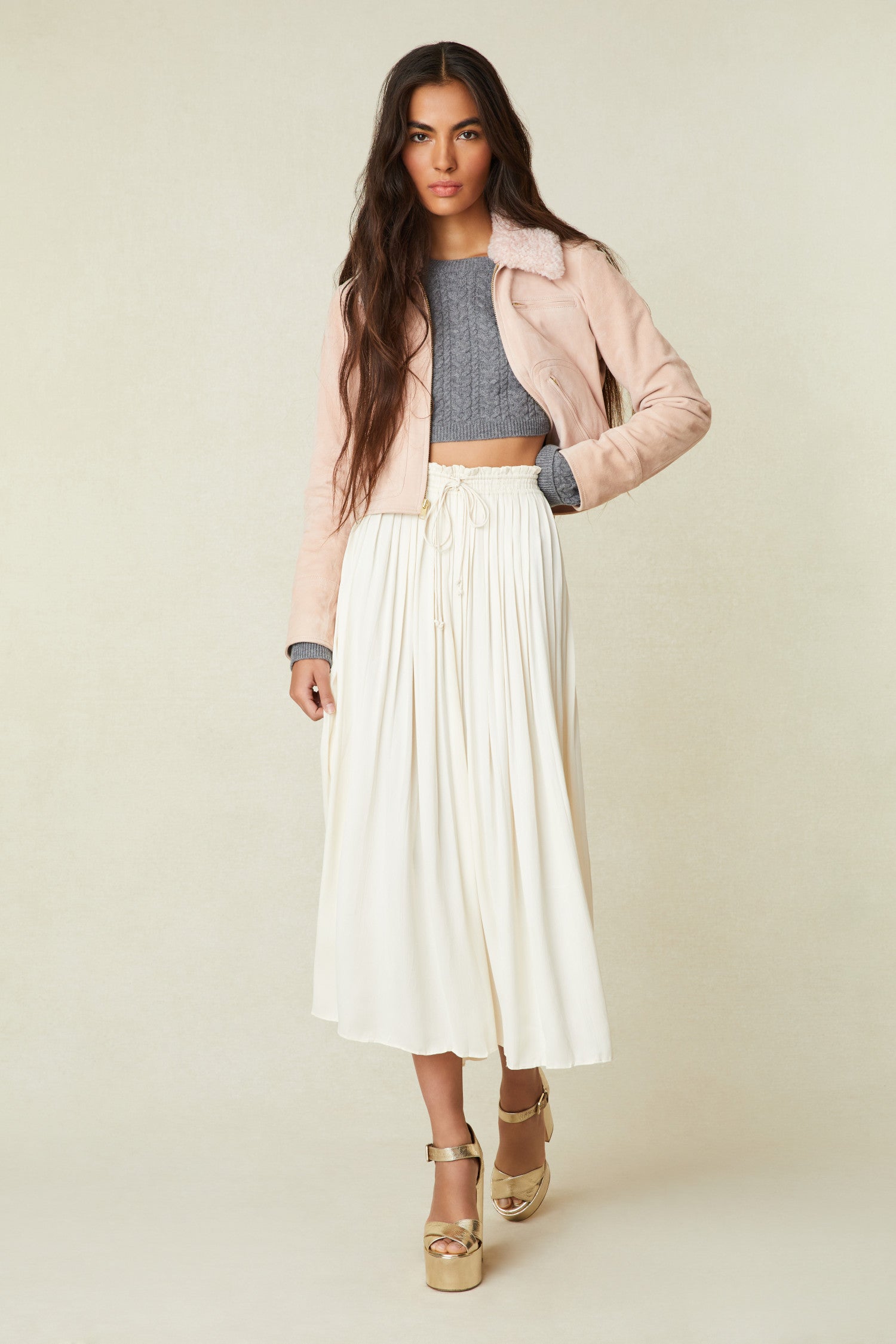 White midi skirt features vertical pleats that fade out at the hem, a drawstring tie at the front and the waist has elastic.