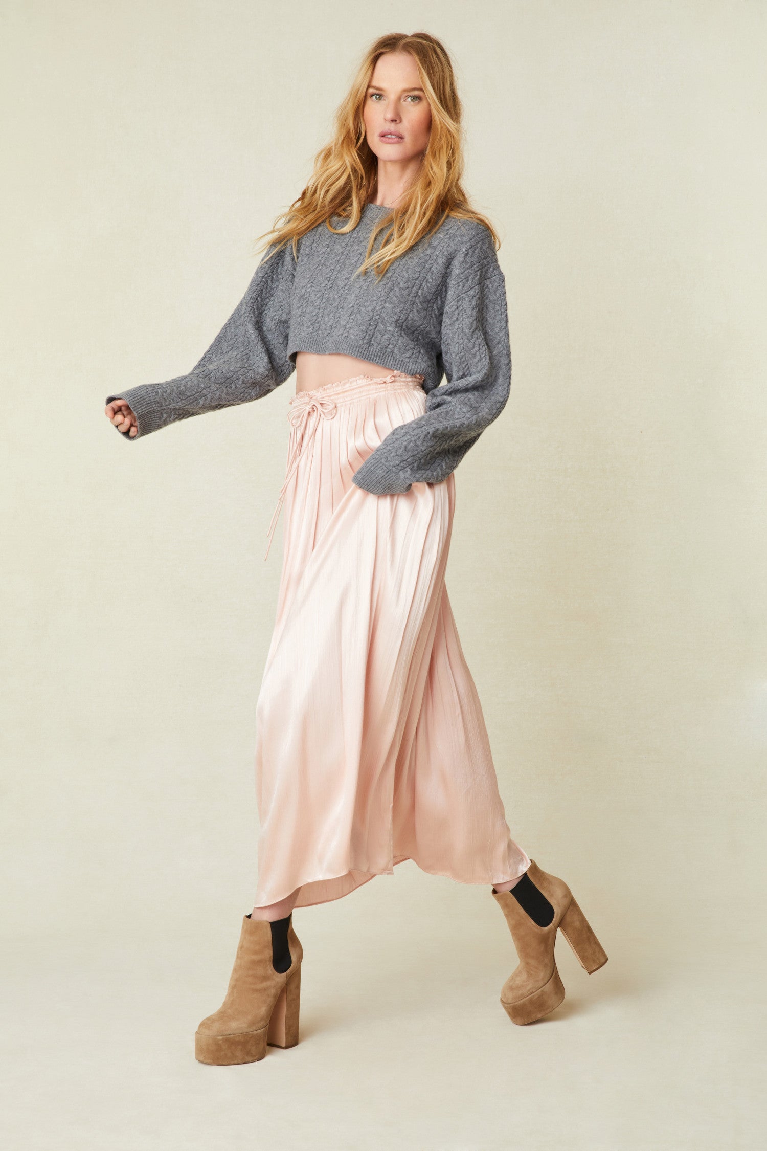 Light Pink Midi Skirt features vertical pleats that fade out at the hem, a drawstring tie at the front at the waist 