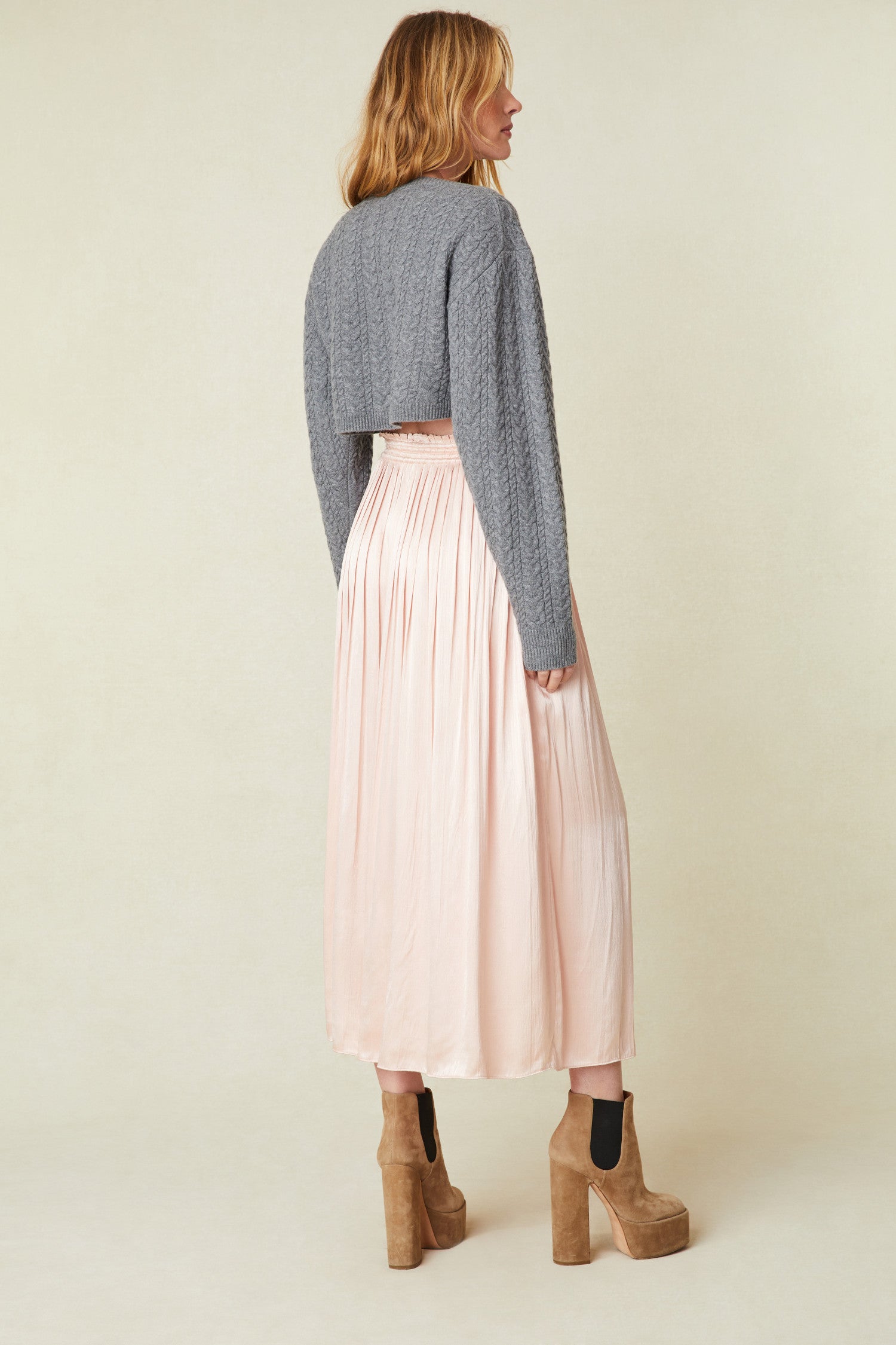 Light Pink Midi Skirt features vertical pleats that fade out at the hem, a drawstring tie at the front at the waist 