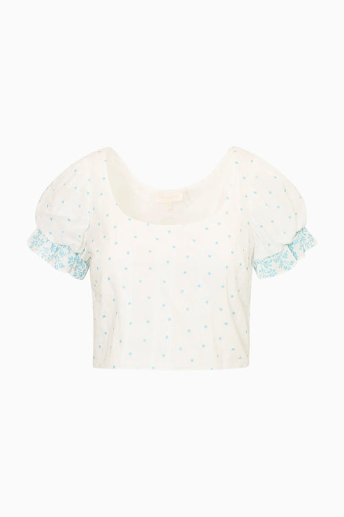 White blouse with blue ruffled sleeves on a white background