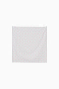Blue fabric square with a subtle floral pattern on a white background