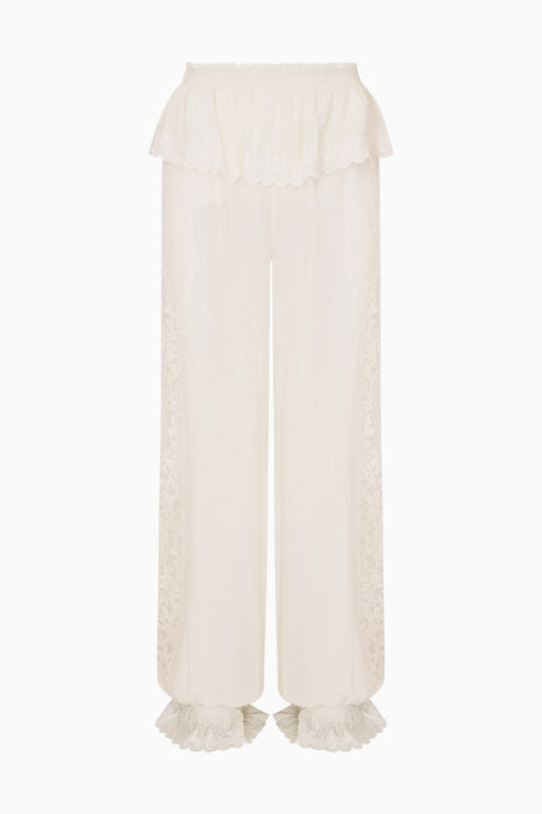 White pants with ruffled cuffs on a white background