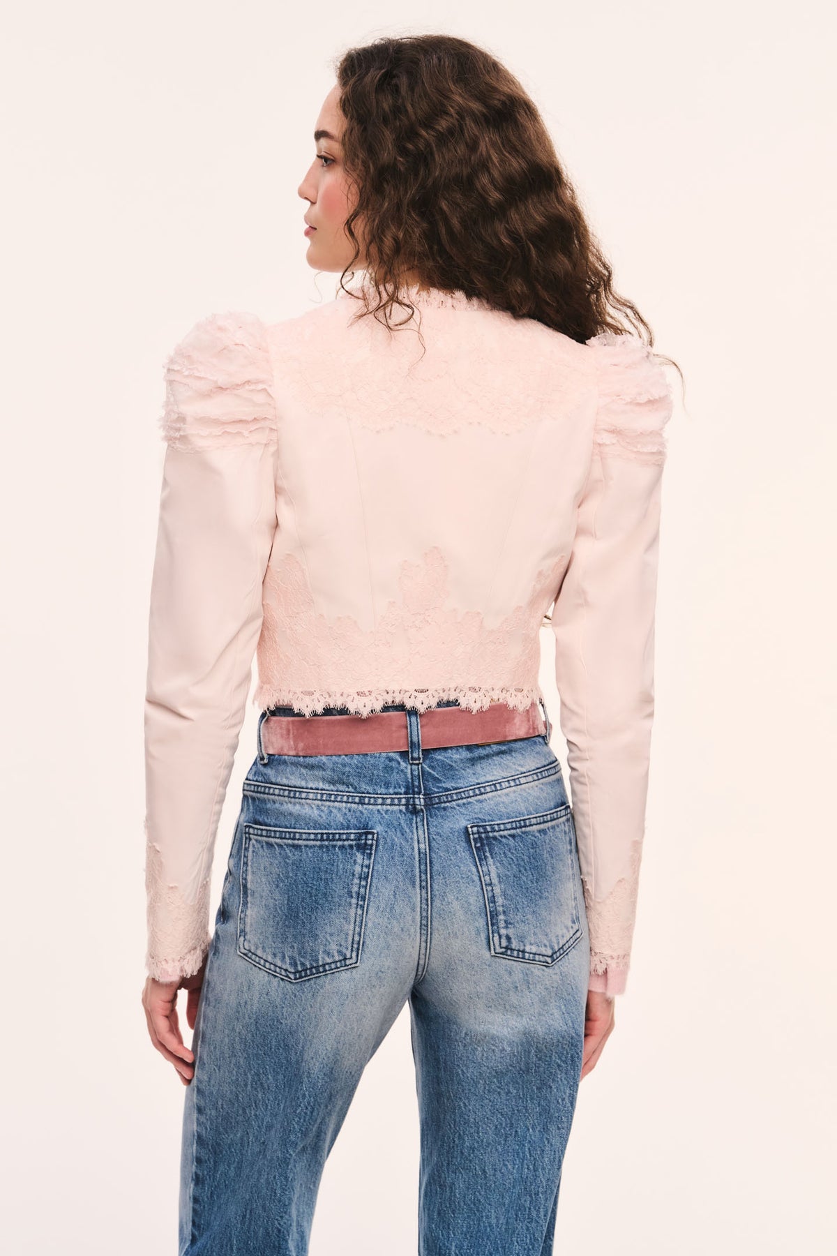 Light pink cropped jacket back view with puff sleeves, and lace-trim ruffle edges