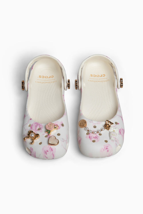 Floral design rubber clogs with decorative elements on a white background