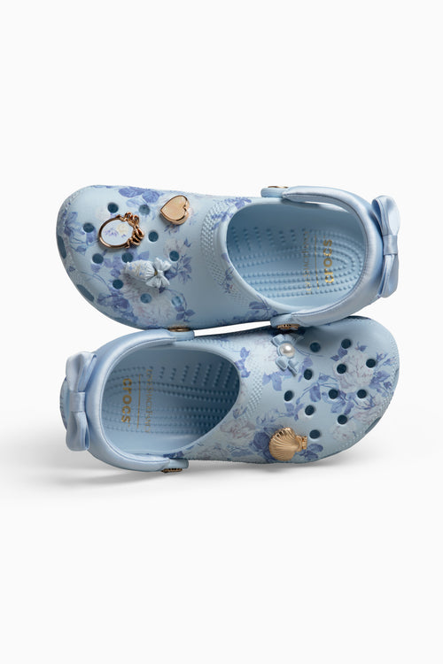 Pair of light blue croc clogs sandals with floral patterns on a white background
