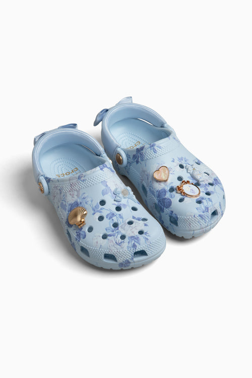Pair of light blue croc clogs sandals with floral patterns on a white background