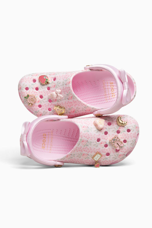 Pink clog shoes with decorative elements on a white background