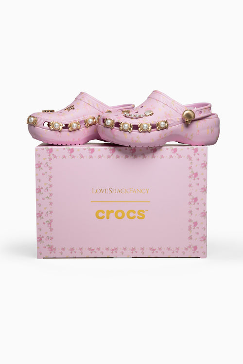 Pink crocs with embellishments on a pink 'crocs' box