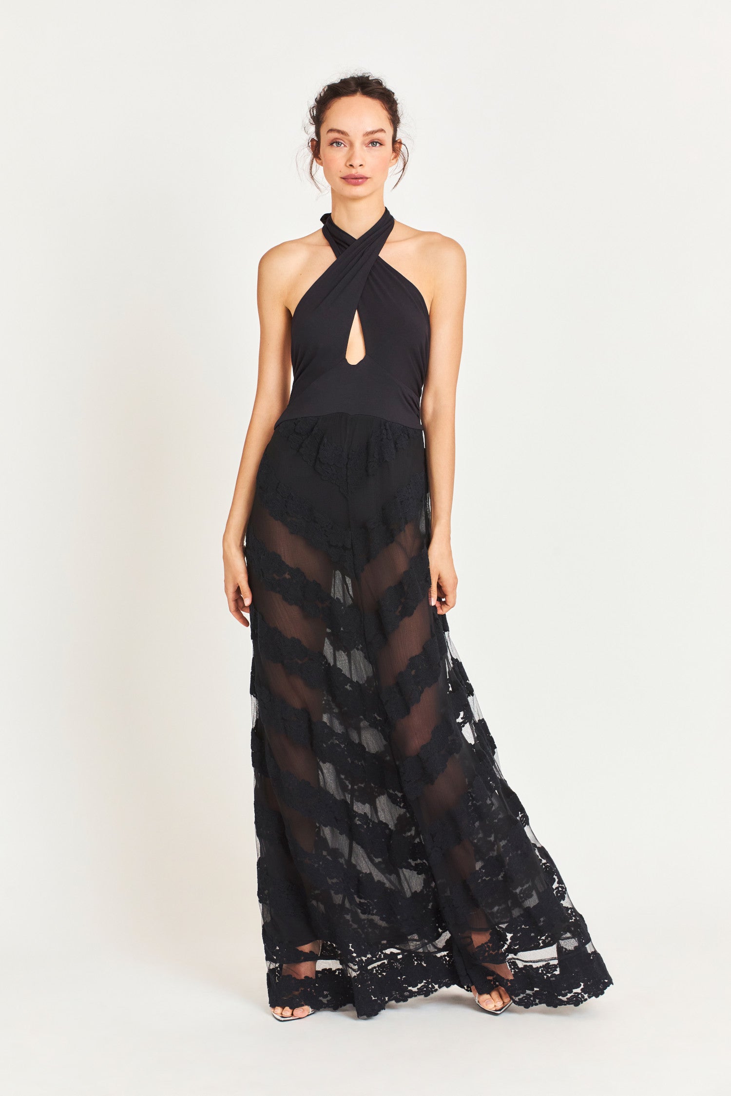 Model wearing black maxi dress with sheer skirt