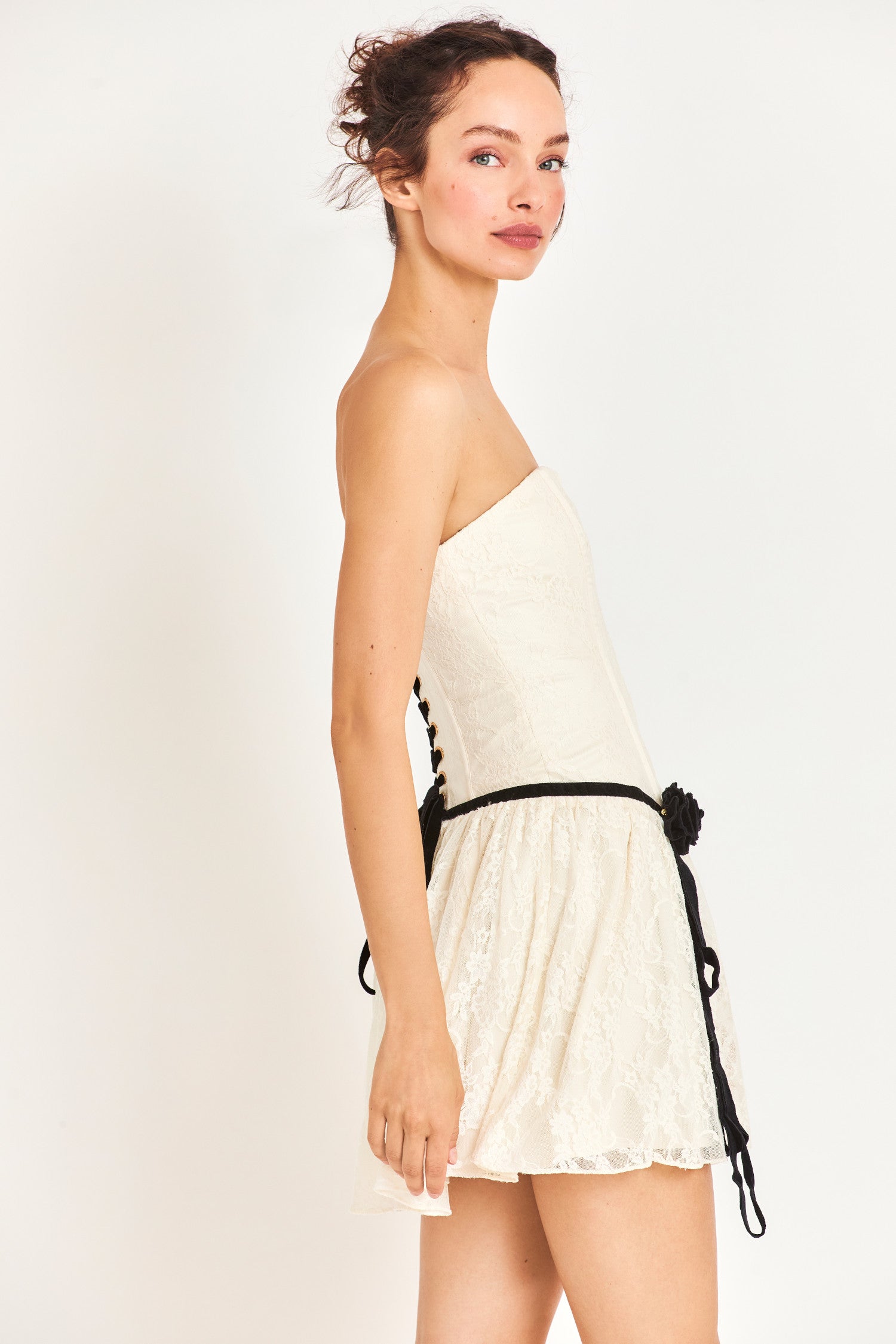 Side image of model wearing white mini dress