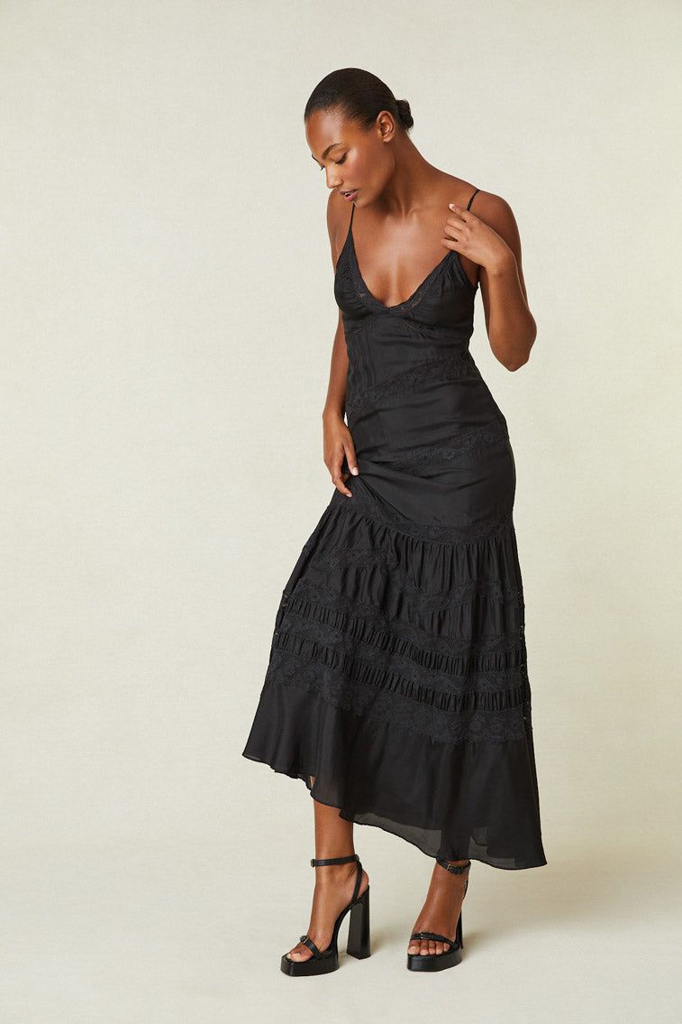 Model wearing black maxi silk dress with lace detail