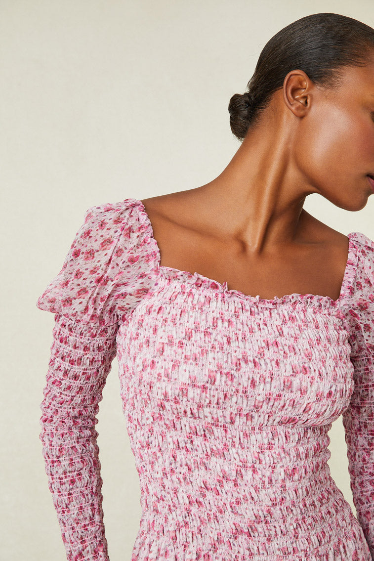 Close up image detailing sleeves and top of pink floral maxi dress. 