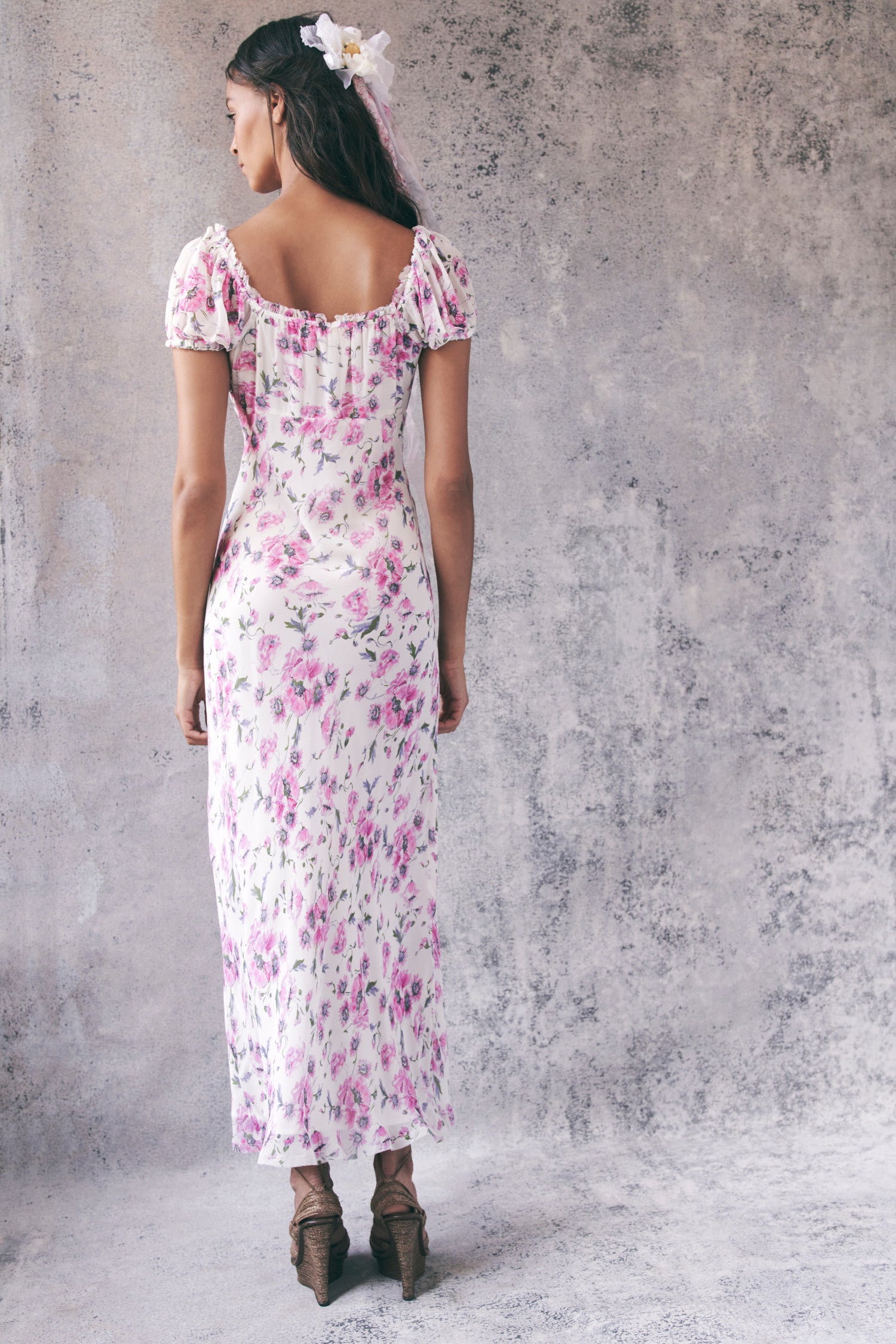 Back image of model wearing pink and white floral short sleeve maxi dress