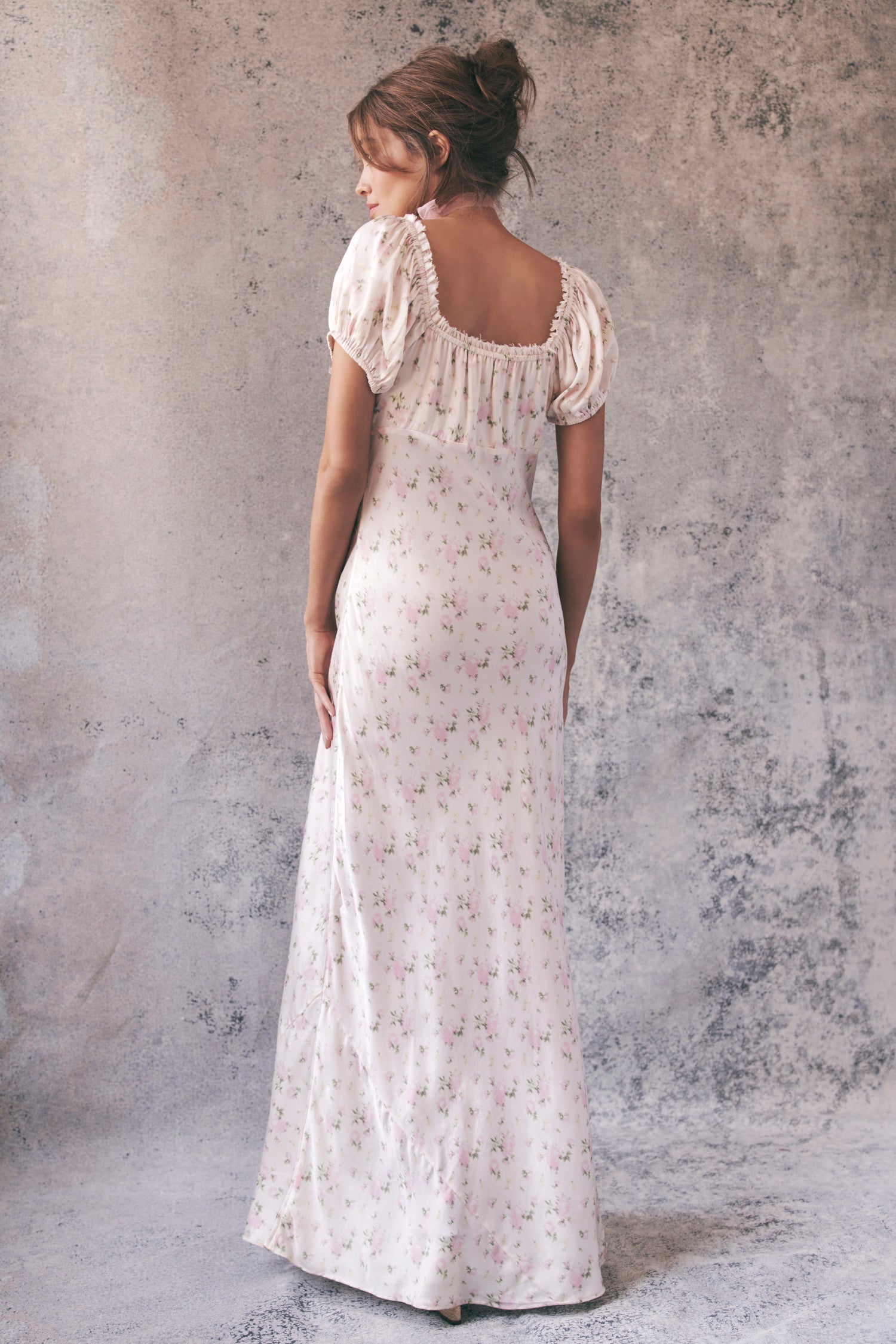 Back image of model wearing cream floral maxi dress